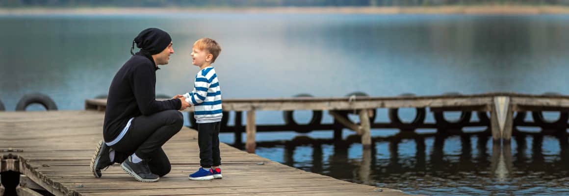 Man holding kid hands