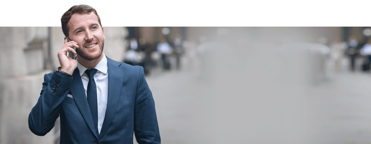 Man in blue suit talking over phone