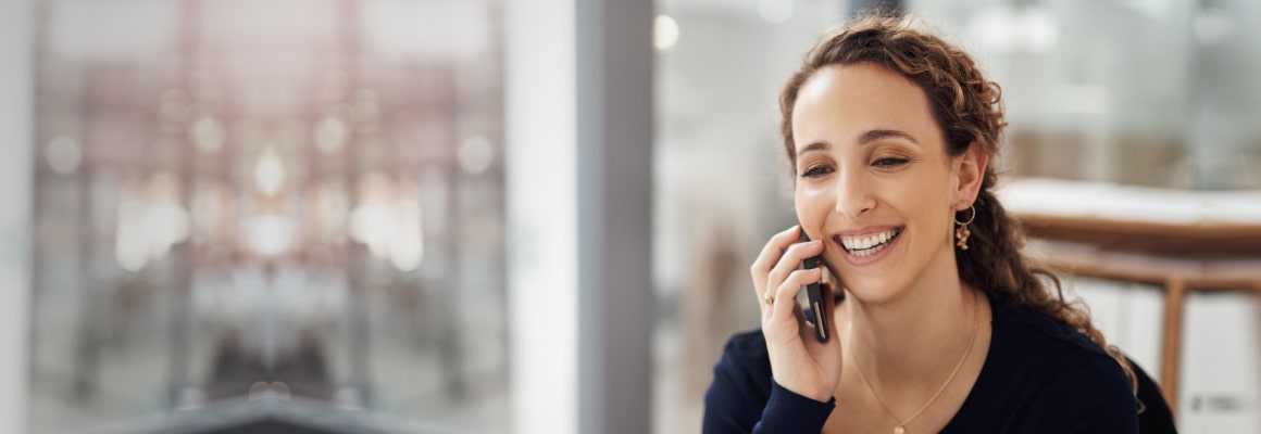Smiling woman taking on phone